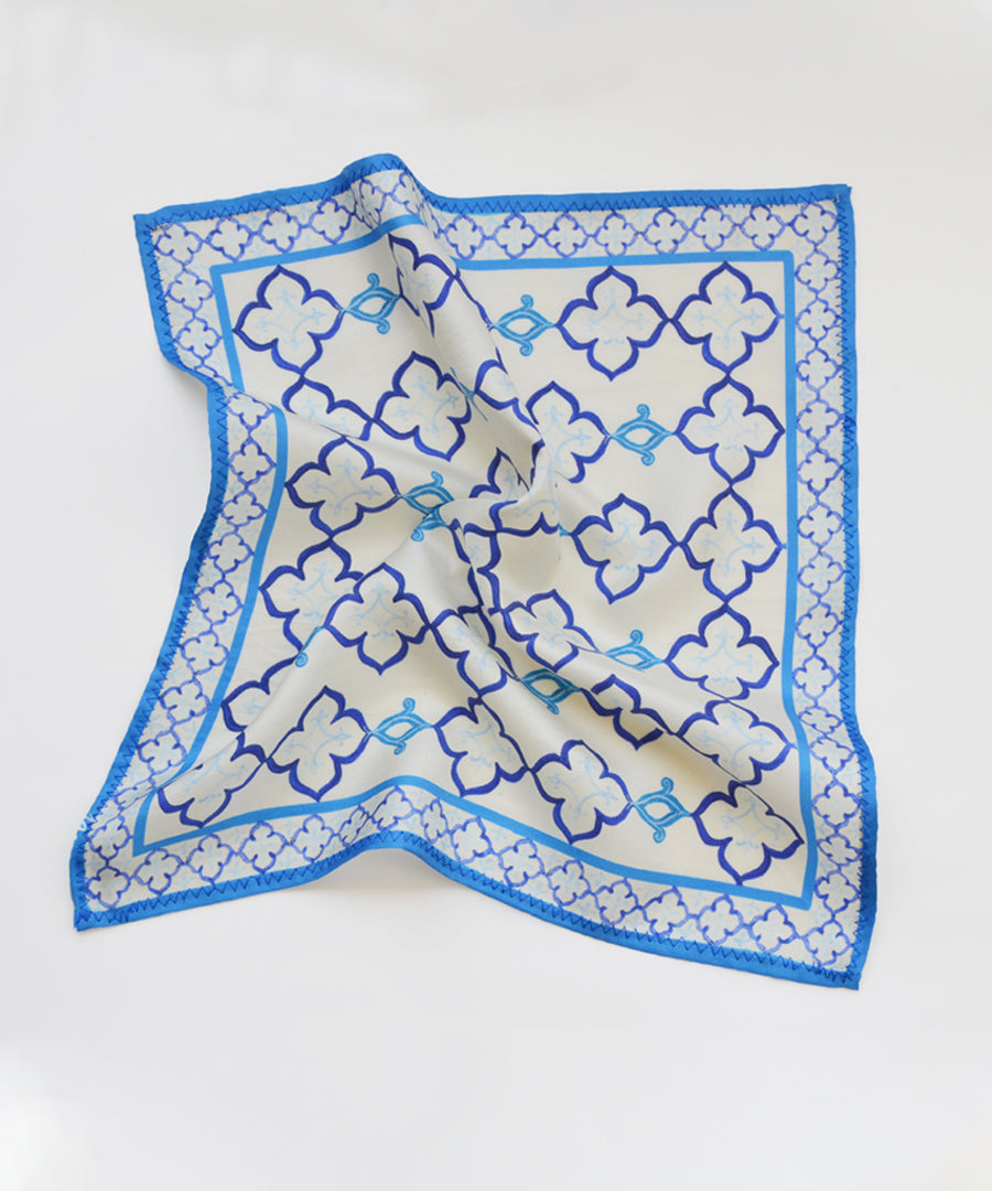 Blue and white patterned square scarf on a white background