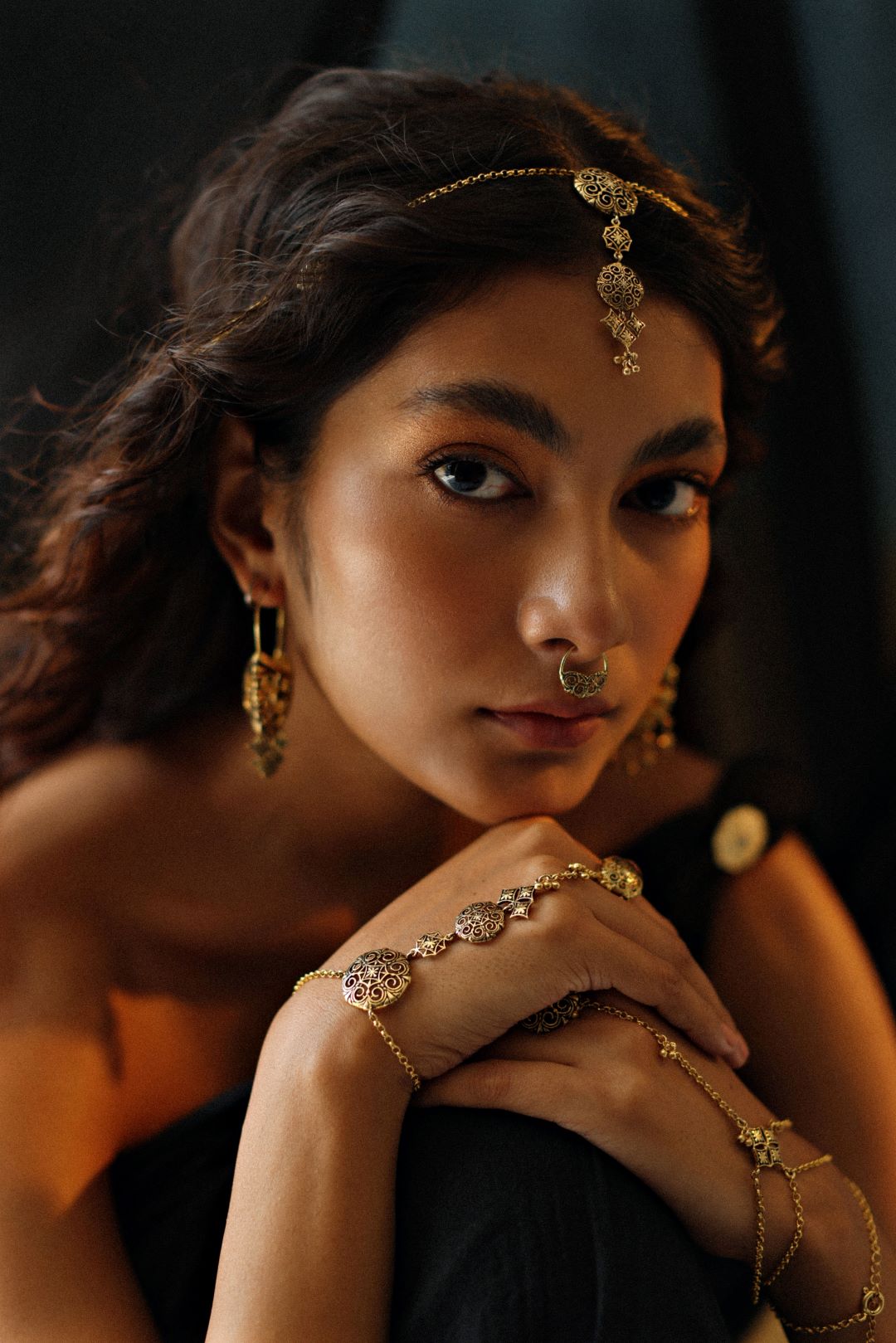 Model wearing chokho hathphool gold plated bracelet hancrafted in 925 silver with oxidised finish.