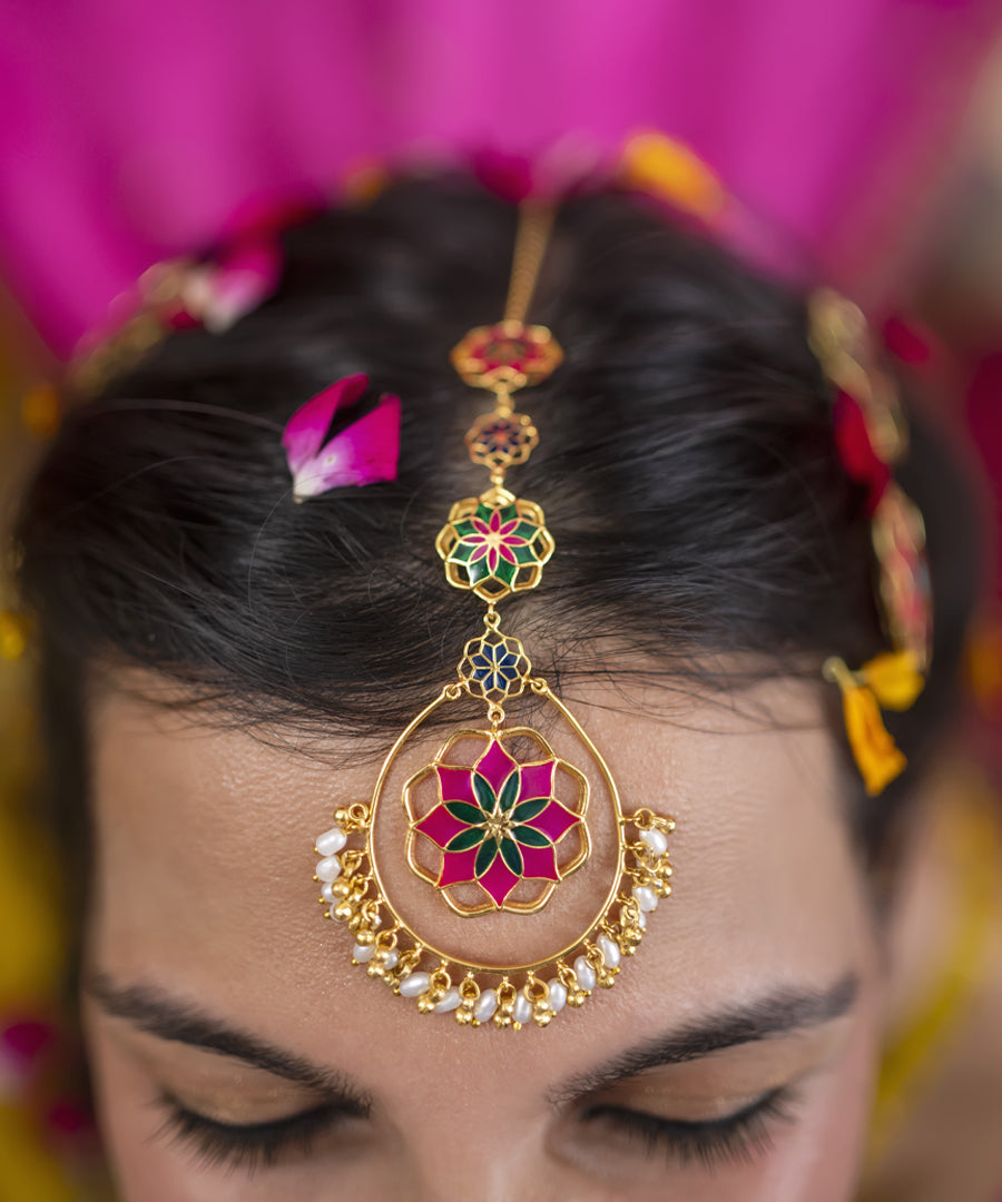 Model wearing pink gul roja tika. Indian design maang tikka made from sterling silver.
