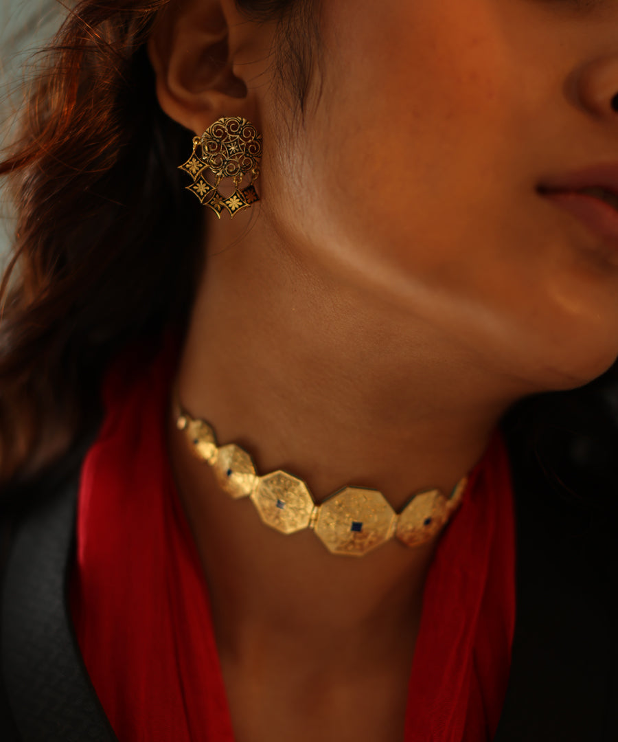 Model wearing handmade gold choker with blue enamel work.