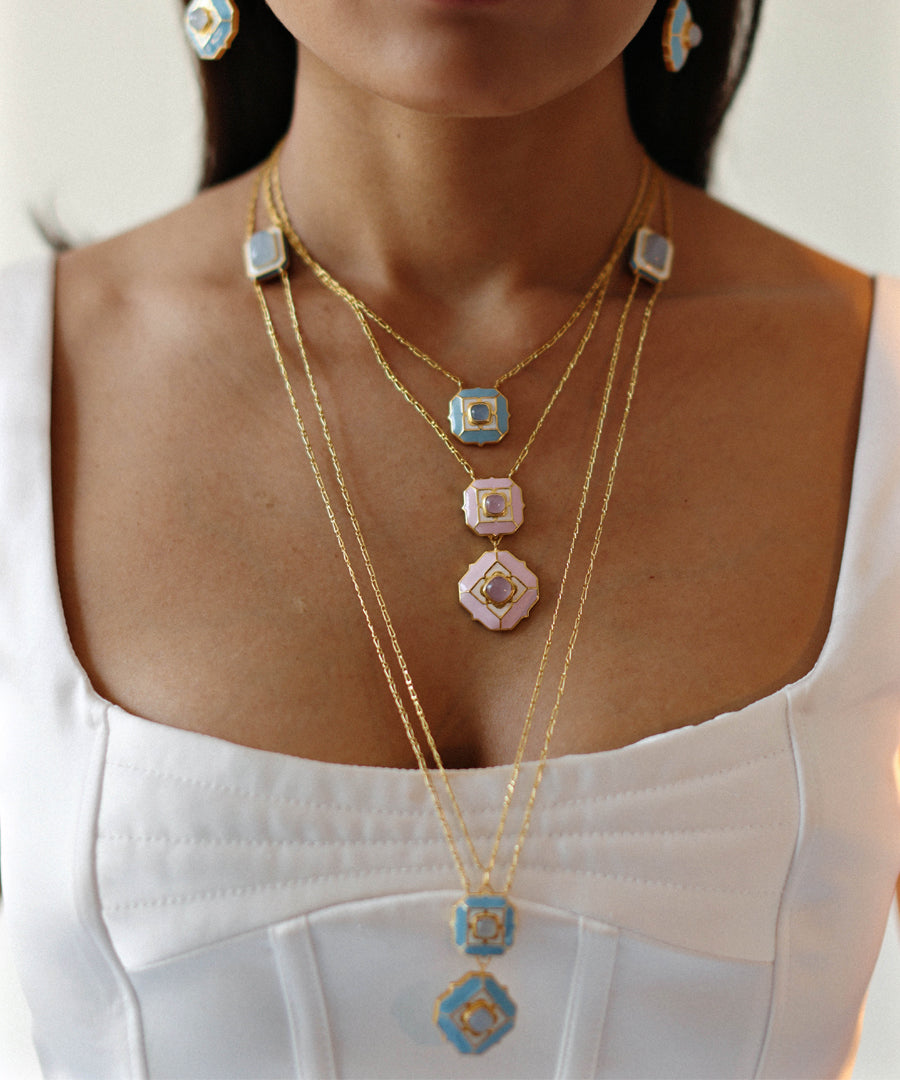 Model wearing blue octa necklace and pink deep dive necklace from tranquil collection by manner india.