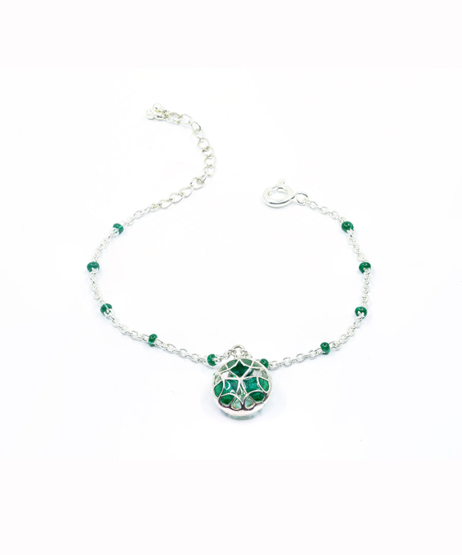 Green adjustable tarnishfree water resistant charm bracelet.