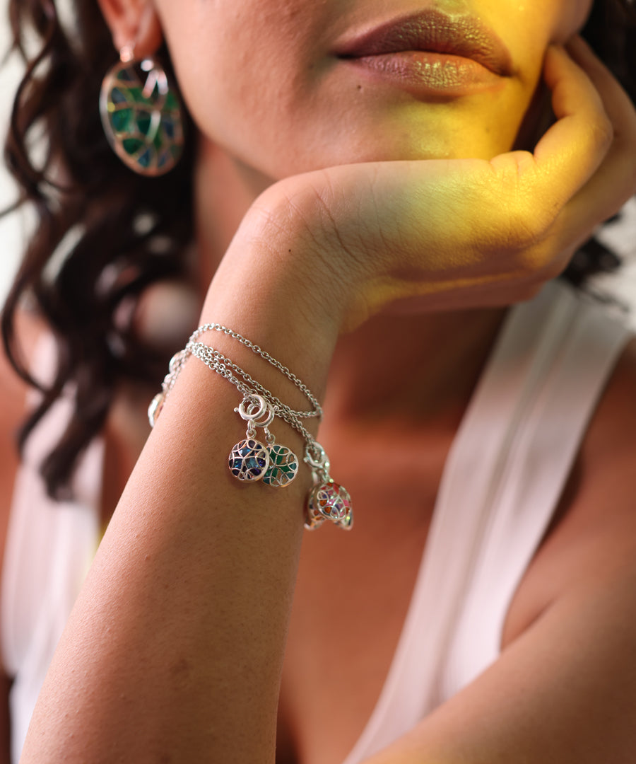 Model wearing layered chain bracelet in sterling silver.