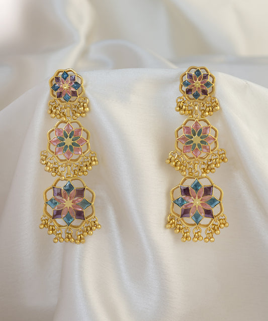 Pink earrings lying on silk cloth. 92.5% sterling silver gold plated earrings from Gul collection by Manner India.