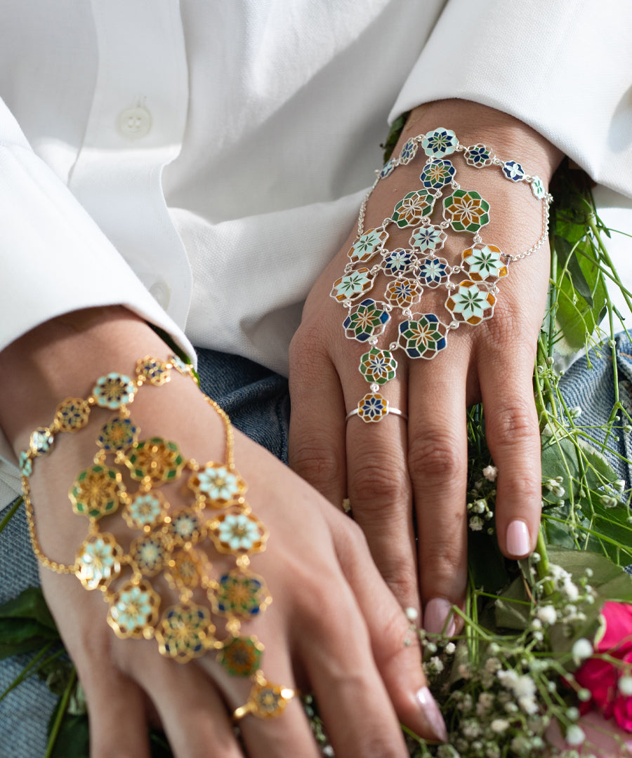 Close-up of hands wearing floral hand jewelry 